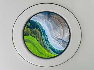 ock photo ID: 1732657280. Concept symbol image greenwashing washing machine with deformed beautiful landscape inside